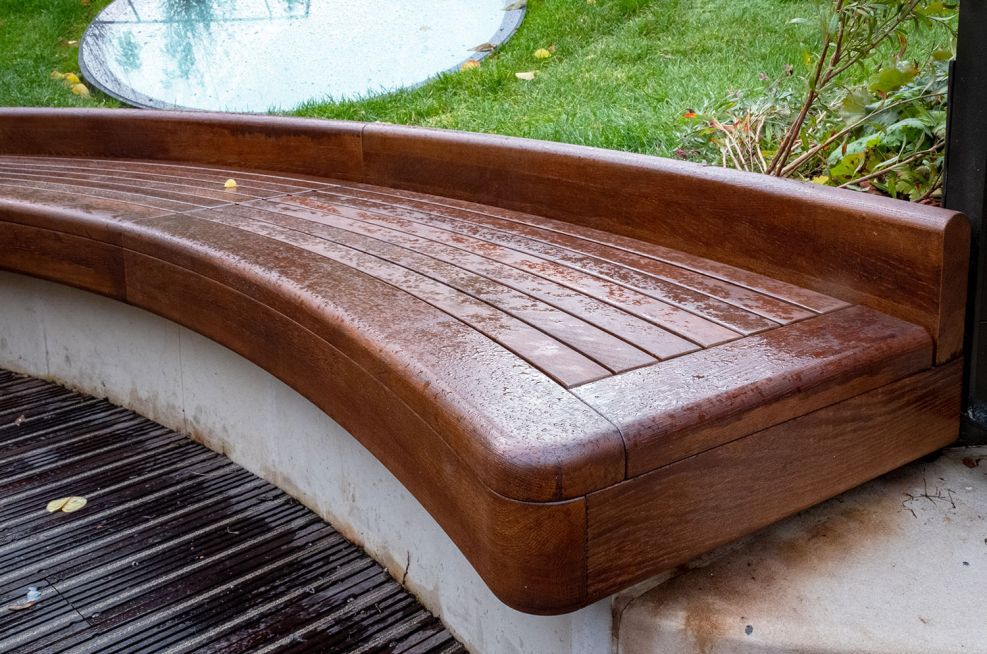 Bespoke curved timber seating for courtyard garden IOTA ESI