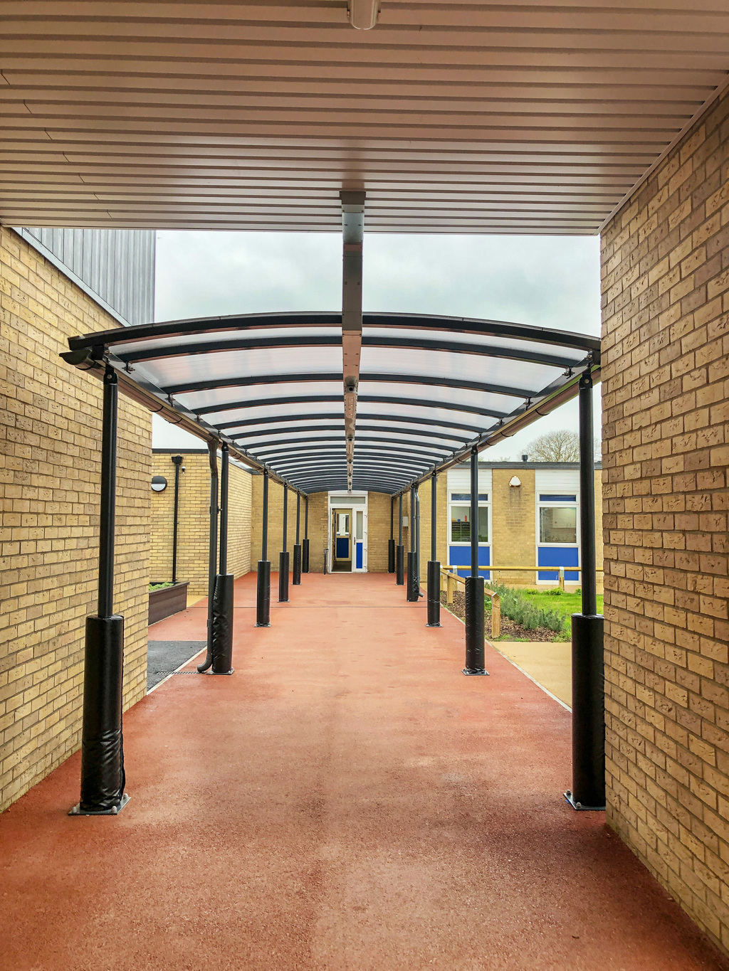 Canopies, covered walkways and planter/seats for school | Langley ...