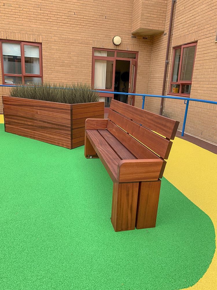 Timber seating & planters for hospital courtyard | Bailey Streetscene