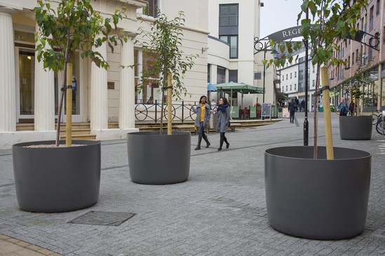 Large round FRC planters in pedestrianised area