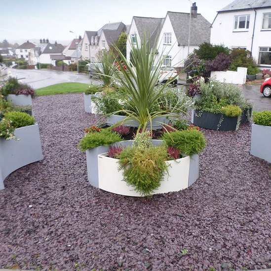 Black and white planters brighten central community area Artform