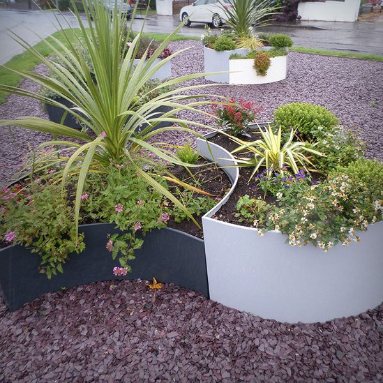 Black and white planters brighten central community area Artform