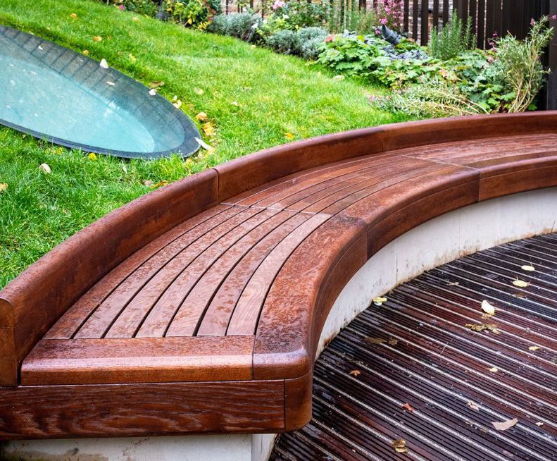 Bespoke curved timber seating for courtyard garden IOTA ESI