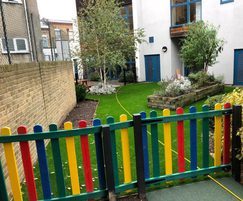 Play area with recycled plastic multicoloured fencing