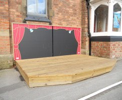 Outdoor timber play stage with backdrop