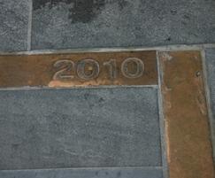 Bronze feature paving strip with date panel.