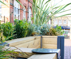 Wooden seating and planter parklet