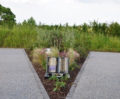 Wildflowers surround memorial art in V shaped path