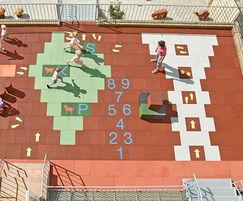 Playground impact protection tiles with design motifs