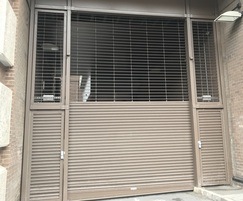 Hybrid grille and shutter with integral hinged doors