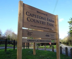 Wooden routed sign at entrance to park