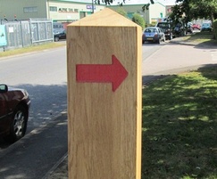 Wooden waymarker post with arrow