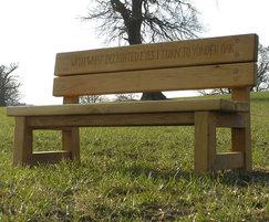 Green oak double-back bench with hand-carved lettering